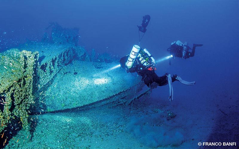 Technical divers examining a historical wreck in deep Adriatic water