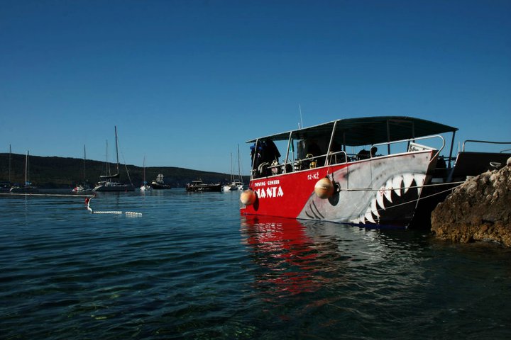 Manta boat in clear water at the Komiža quay